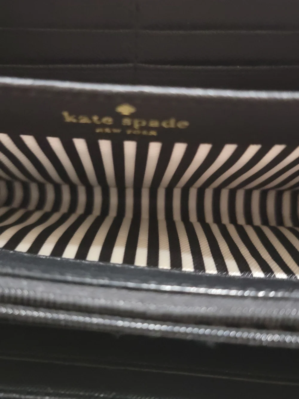 kate spade black zip-around Saffiano leather wallet with gold logo